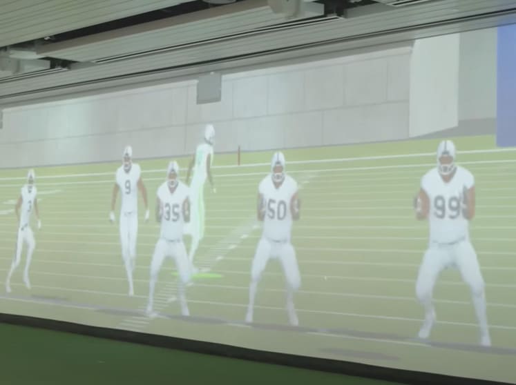 Images of defense opponents projected on the Walk Through Wall at Texas A&M.